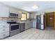 Remodeled kitchen featuring stainless steel appliances, light colored cabinets and tile backsplash at 2021 E 9Th St, Anderson, IN 46012