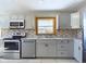 Beautiful kitchen featuring stainless steel appliances, gray cabinets, and tile backsplash at 2021 E 9Th St, Anderson, IN 46012
