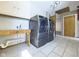 A laundry room showcasing modern washer and dryer units, cabinets, and tile flooring at 2021 E 9Th St, Anderson, IN 46012