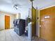 Laundry room featuring modern washer and dryer units, and a door at 2021 E 9Th St, Anderson, IN 46012