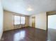 Traditional living room featuring neutral walls, hardwood floors, and natural light from a window at 2021 E 9Th St, Anderson, IN 46012