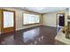 Spacious living room featuring gleaming wood floors and a view into the kitchen at 2021 E 9Th St, Anderson, IN 46012