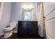 Bathroom showcasing a dark vanity, toilet, mirror, and shower curtain at 208 Coatsville Dr, Westfield, IN 46074