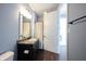 Bathroom features a dark vanity with a sink and a mirror at 208 Coatsville Dr, Westfield, IN 46074