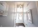 Bright foyer features a chandelier, front door with transom window, and neutral paint at 208 Coatsville Dr, Westfield, IN 46074