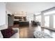 Open kitchen with stainless appliances, an island with sink, and an adjacent dining area at 208 Coatsville Dr, Westfield, IN 46074