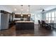 Kitchen view features an island with pendant lights, stainless steel appliances, and a table with chairs at 208 Coatsville Dr, Westfield, IN 46074