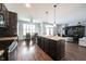 Open kitchen featuring dark cabinets, an island with sink, and an adjacent dining area at 208 Coatsville Dr, Westfield, IN 46074