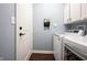 Bright laundry room features white appliances, cabinetry, and a convenient mail station by the entry door at 208 Coatsville Dr, Westfield, IN 46074