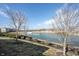 Scenic pond view with mature trees in a well-maintained community, providing a tranquil and natural backdrop at 208 Coatsville Dr, Westfield, IN 46074
