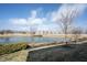 Picturesque pond view with manicured landscaping and mature trees, enhancing the serene ambiance of the property at 208 Coatsville Dr, Westfield, IN 46074