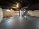 A finished basement offers a blank canvas and features painted floors, and exposed beams at 220 Huffman Rd, Columbus, IN 47201