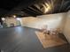 A finished basement offers a blank canvas and features painted floors, and exposed beams at 220 Huffman Rd, Columbus, IN 47201