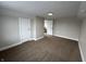 This carpeted bedroom is freshly painted in neutral colors with white trim and features multiple doors at 220 Huffman Rd, Columbus, IN 47201