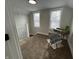 This bright bedroom features neutral walls, carpeted floors, and two windows for natural light at 220 Huffman Rd, Columbus, IN 47201