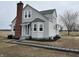 Charming two-story home with a brick chimney and a landscaped yard at 220 Huffman Rd, Columbus, IN 47201