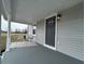 Cozy front porch featuring seating, a decorative rug, and a freshly painted front door at 220 Huffman Rd, Columbus, IN 47201
