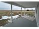 Spacious covered porch with comfortable seating, stylish rug, and a scenic view at 220 Huffman Rd, Columbus, IN 47201