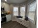 Cozy kitchen nook with built-in seating surrounded by bright, sunny windows at 220 Huffman Rd, Columbus, IN 47201