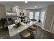 Modern kitchen featuring island with seating, stainless appliances, and window nook at 220 Huffman Rd, Columbus, IN 47201