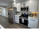 Bright kitchen featuring stainless steel appliances, white cabinets, and modern countertops at 220 Huffman Rd, Columbus, IN 47201