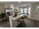 Modern kitchen featuring island with seating, stainless appliances, and window nook at 220 Huffman Rd, Columbus, IN 47201