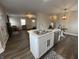 Open-concept kitchen with marble island, stainless steel appliances, and views to the living room at 220 Huffman Rd, Columbus, IN 47201