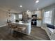 Modern kitchen with stainless steel appliances, island seating, and ample countertop space at 220 Huffman Rd, Columbus, IN 47201
