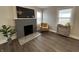 Inviting living room with a brick fireplace, wood floors, and natural light at 220 Huffman Rd, Columbus, IN 47201