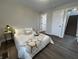 Bedroom with neutral tones, hardwood floors, and staircase access at 220 Huffman Rd, Columbus, IN 47201