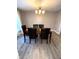 Dining room featuring wood table with leather chairs under decorative light fixture and wood-look floors at 2284 Horizon Blvd, Greenwood, IN 46143