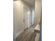 Hallway with multiple doors and a table with decor, featuring white trim and neutral walls at 2284 Horizon Blvd, Greenwood, IN 46143