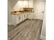 Basement kitchenette area with white cabinets, wooden countertop, and vinyl flooring at 2284 Horizon Blvd, Greenwood, IN 46143