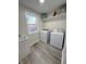 Bright laundry room featuring a washing machine, dryer, sink, and a window with a view at 2284 Horizon Blvd, Greenwood, IN 46143