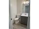 Bathroom featuring a toilet, vanity with silver hardware, modern lighting and wood-look floors at 2284 Horizon Blvd, Greenwood, IN 46143