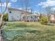 A spacious backyard featuring a large lawn and a deck with a pergola, ideal for outdoor living at 2311 Lammermoor Ln, Indianapolis, IN 46214
