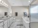 Bright bathroom featuring marble floors, granite counters, a soaking tub, and a glass-enclosed shower at 2311 Lammermoor Ln, Indianapolis, IN 46214