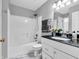 Bathroom featuring marble floors, a shower-tub combo, and a vanity with a black countertop at 2311 Lammermoor Ln, Indianapolis, IN 46214