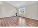 Bright bedroom features a large window, neutral walls, and wood-look floors at 2311 Lammermoor Ln, Indianapolis, IN 46214