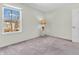 Bedroom featuring neutral carpet, a window offering natural light, and a decorative side table at 2311 Lammermoor Ln, Indianapolis, IN 46214