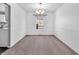 Bright, empty dining room with neutral carpet at 2311 Lammermoor Ln, Indianapolis, IN 46214