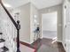Inviting foyer with hardwood floors, staircase, and a decorative table, creating a warm welcome at 2311 Lammermoor Ln, Indianapolis, IN 46214