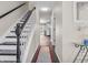 Hallway with staircase and wood floors at 2311 Lammermoor Ln, Indianapolis, IN 46214