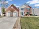 Charming two-story brick home with a two-car garage and well-maintained front lawn at 2311 Lammermoor Ln, Indianapolis, IN 46214