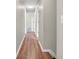 Hallway with wood flooring, neutral walls, and doors leading to other rooms at 2311 Lammermoor Ln, Indianapolis, IN 46214
