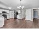 Open concept kitchen with stainless steel appliances, an adjacent eating area, and modern fixtures at 2311 Lammermoor Ln, Indianapolis, IN 46214