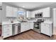 Beautifully updated kitchen with stainless steel appliances, white cabinets, and modern fixtures at 2311 Lammermoor Ln, Indianapolis, IN 46214