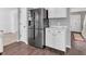 Modern kitchen featuring a stainless steel refrigerator, white cabinets, and hardwood flooring at 2311 Lammermoor Ln, Indianapolis, IN 46214
