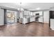 Open kitchen and dining area with stainless appliances, white cabinets, and sliding glass door to the deck at 2311 Lammermoor Ln, Indianapolis, IN 46214