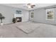Cozy living room featuring a fireplace, large windows, and comfortable carpet at 2311 Lammermoor Ln, Indianapolis, IN 46214